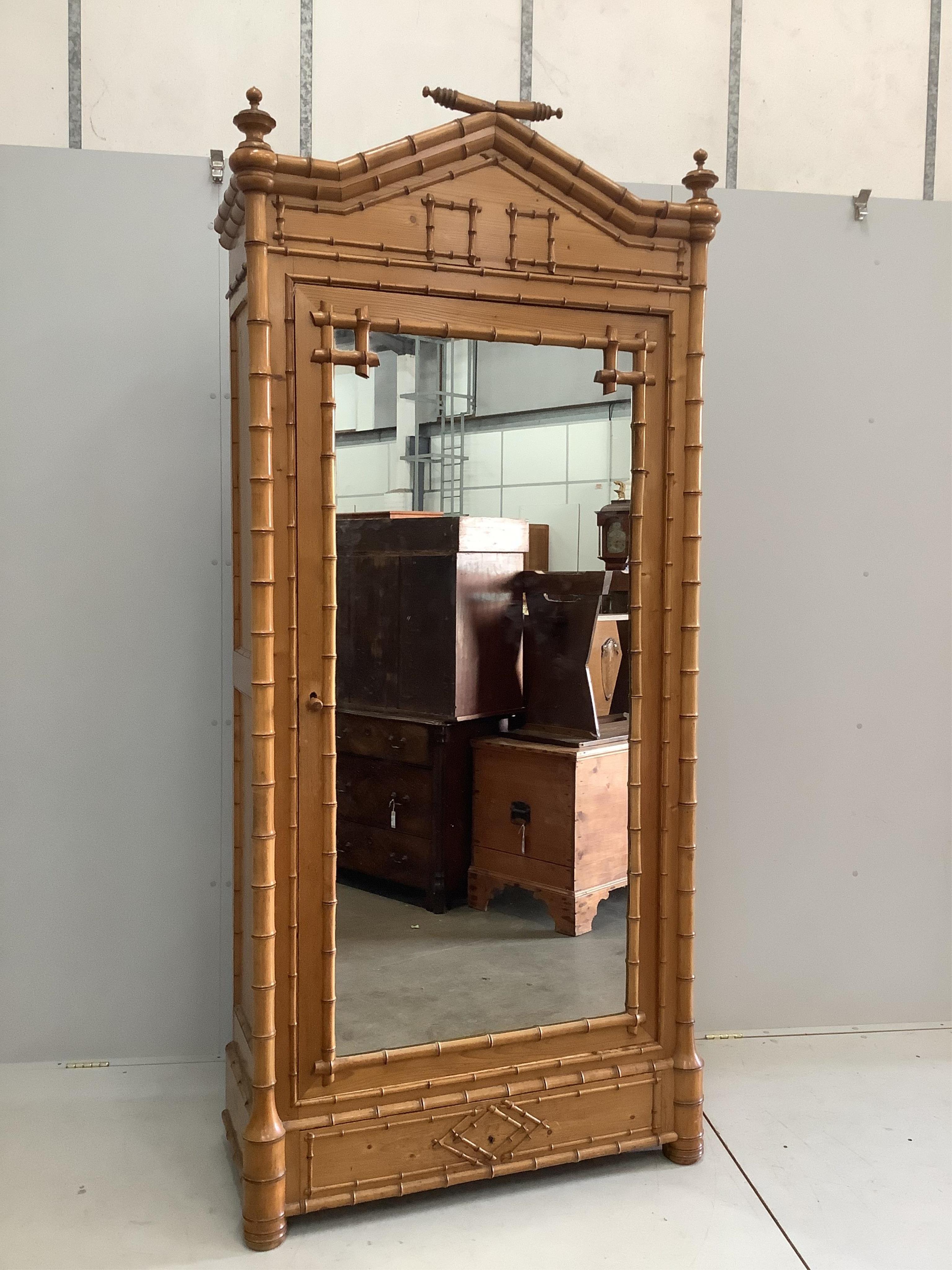 A late Victorian pitch pine faux bamboo mirrored armoire, width 98cm, depth 44cm, height 228cm. Condition - good